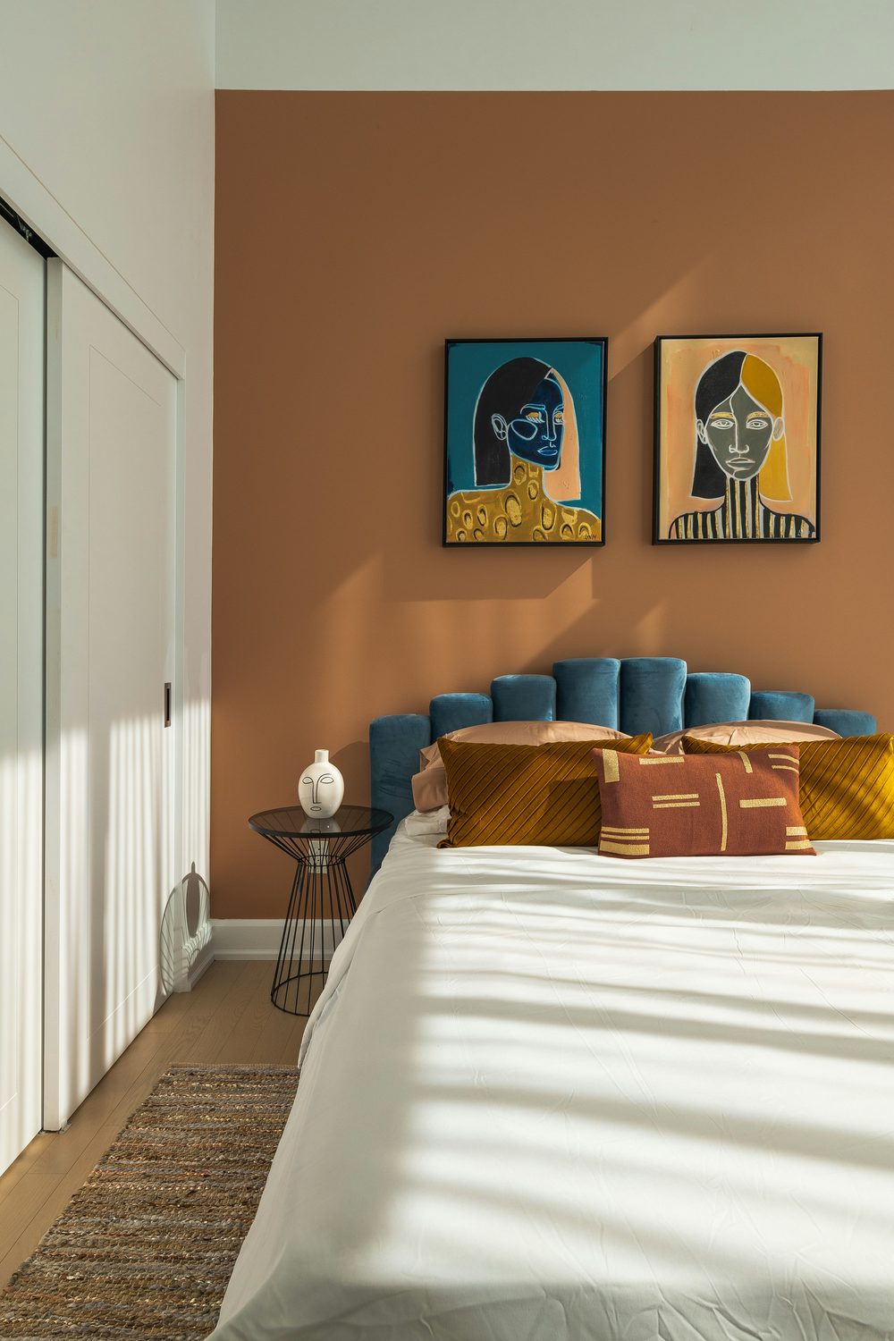 Bold terracotta feature wall in a styled bedroom