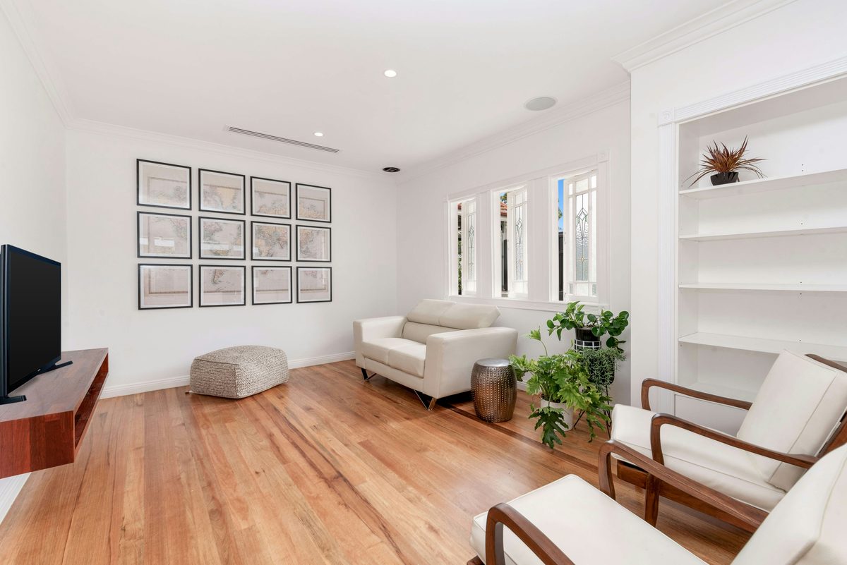 Bright, freshly painted living room with timber floors